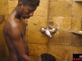 Young African man gives oral sex in the shower before unprotected gay intercourse