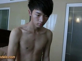 Asian teen boy masturbates revealing big cock and shoots a load